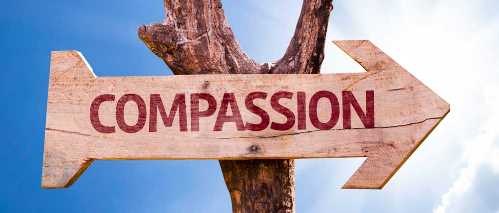 Compassion sign with arrow